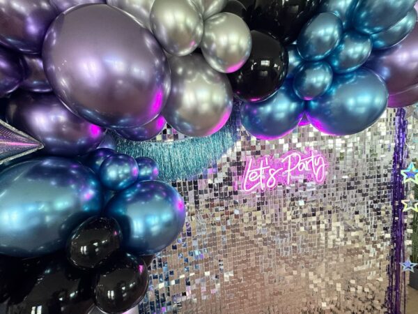 Colorful balloon decoration with "Let's Party" sign.