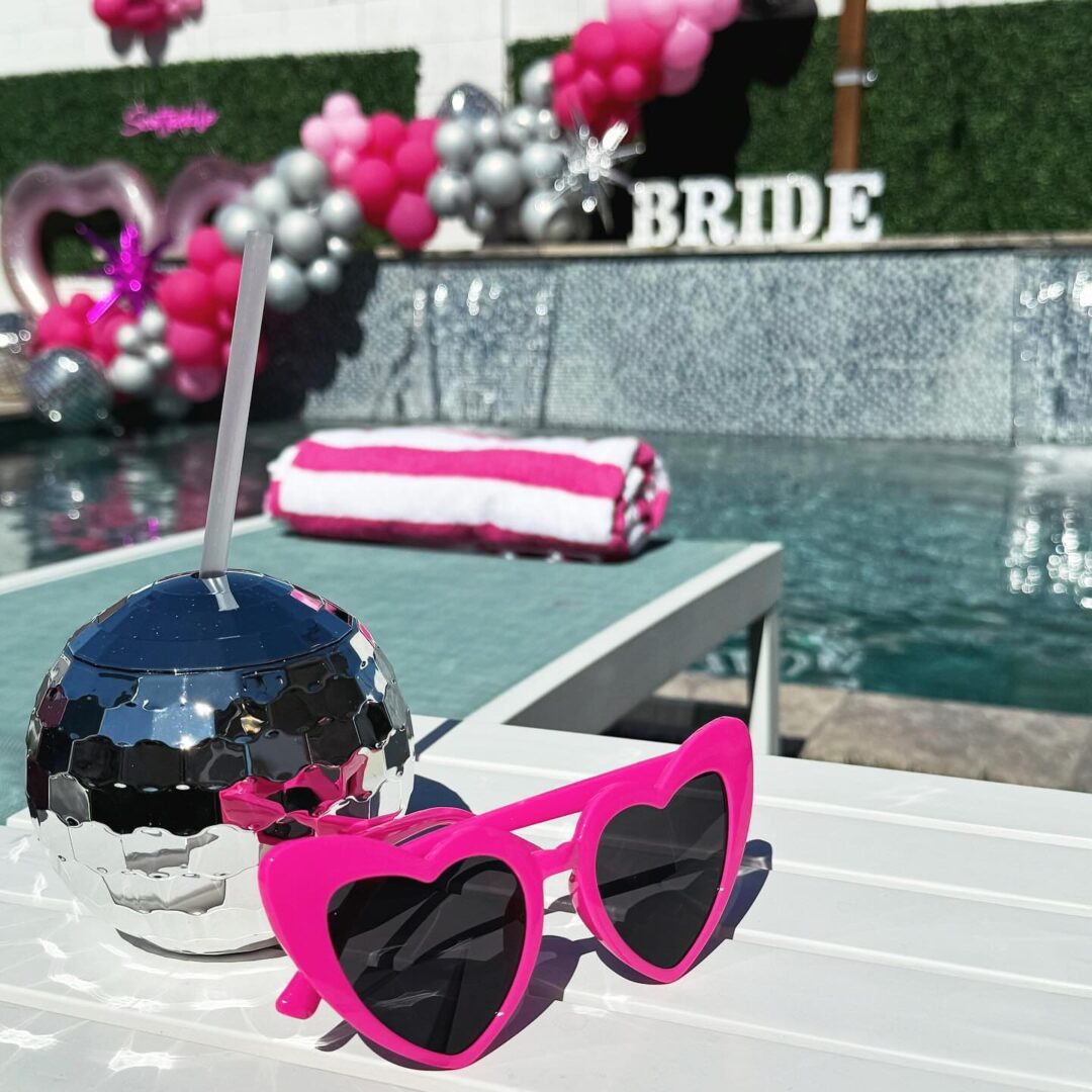 Pink Pony (7) Pink heart sunglasses by a poolside party.